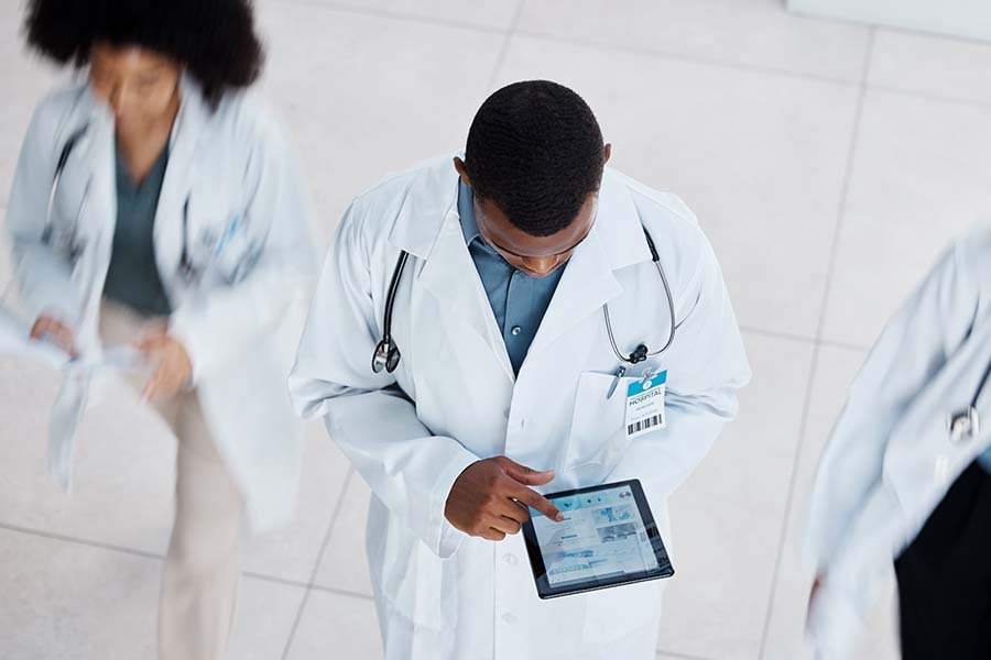 Doctor or nurse in a hospital using a tablet.
