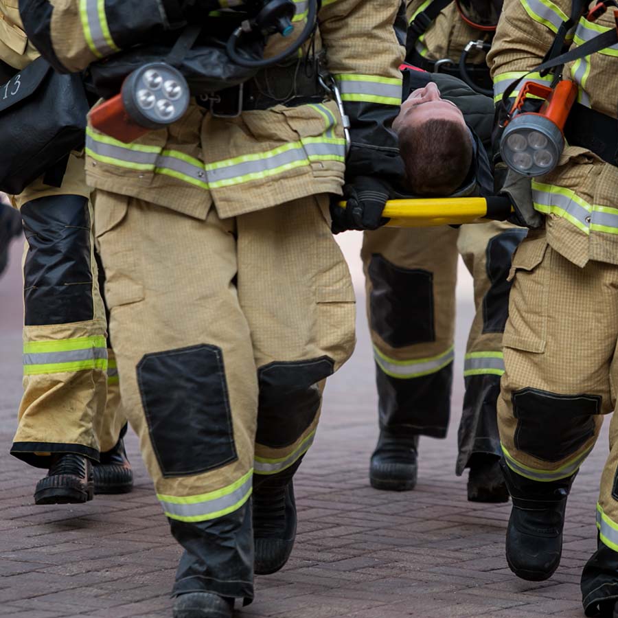 a group of firefighters wearing gear shown from waist down
