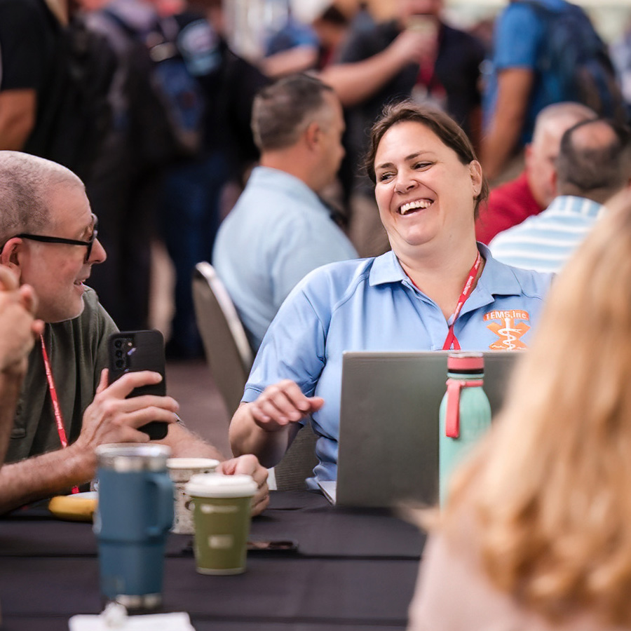 woman sitting at table laughing