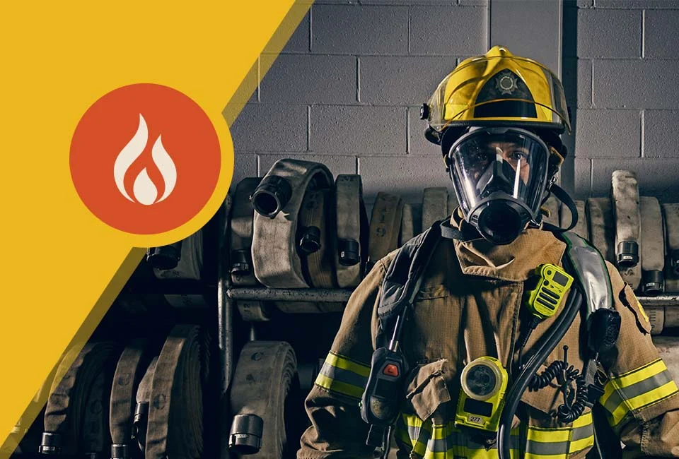 Firefighter in full gear stands in front of stacked hoses. A flame icon is displayed on a yellow background to the left.