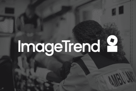 A paramedic tends to a patient inside an ambulance. The ImageTrend logo is prominently displayed over the scene.