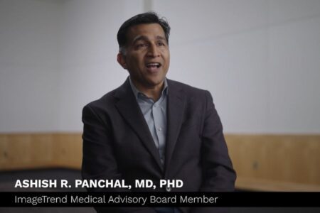 A man in a dark suit jacket sits and speaks in a well-lit room. On-screen text reads "Ashish R. Panchal, MD, PhD, ImageTrend Medical Advisory Board Member.