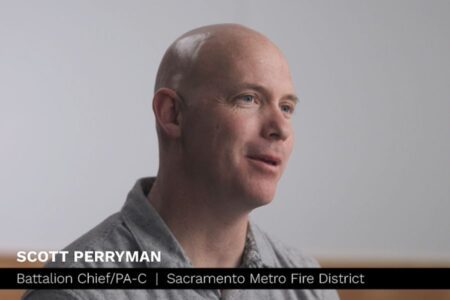 A man with a shaved head wearing a gray collared shirt speaks. Text on image: "Scott Perryman, Battalion Chief/PA-C, Sacramento Metro Fire District.
