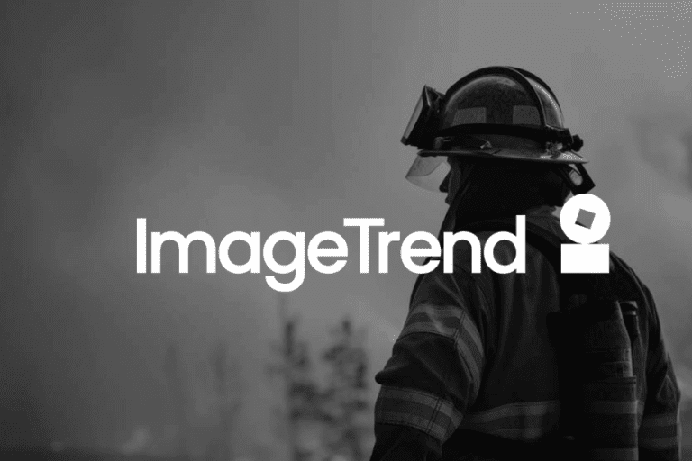 A firefighter in protective gear stands outdoors with smoke in the background; the ImageTrend logo is overlaid on the image.