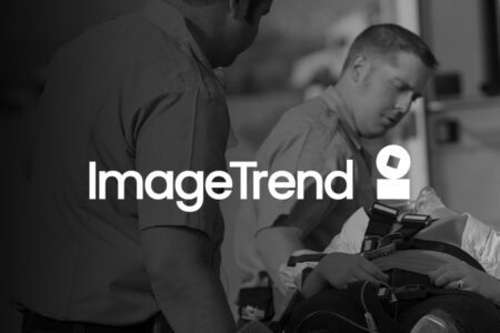Two emergency responders assist a patient on a stretcher; the ImageTrend logo is centered over the image.