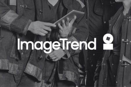 Three people in firefighter jackets look at a tablet. The words "ImageTrend" and a logo are overlaid on the image.