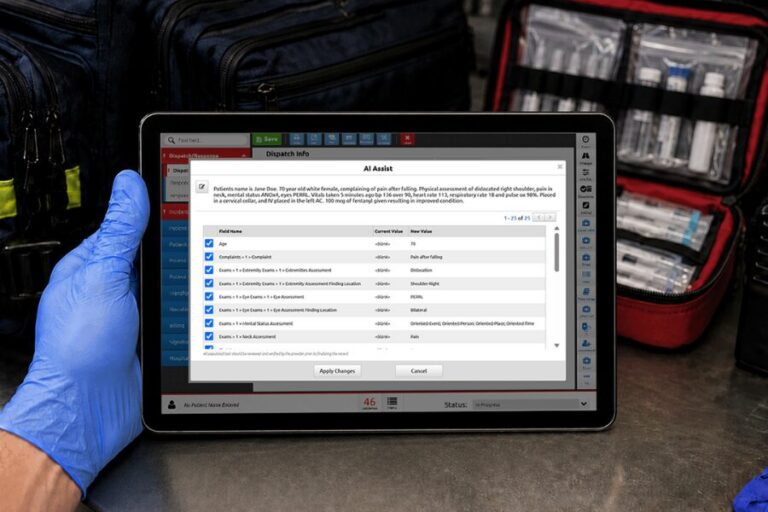 A gloved hand holds a tablet displaying medical software with an AI Assist window open; medical supplies, including prehospital blood, are visible in the background.