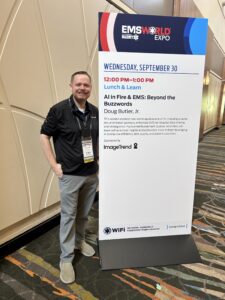 Doug Butler, Jr. stands next to an EMS World Expo sign for a session on AI in Fire and EMS, a topic relevant to the evolution of NERIS, titled “Beyond the Buzzwords.”